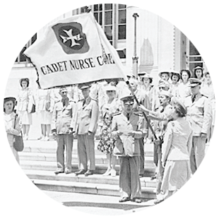 Cadet Nurse Corps officers wave a flag.